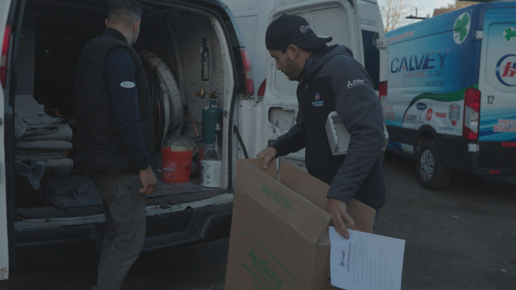 Calvey Heating & Air Technicians loading up the van
